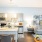 Kitchen with grey cabinets and island opening to living room