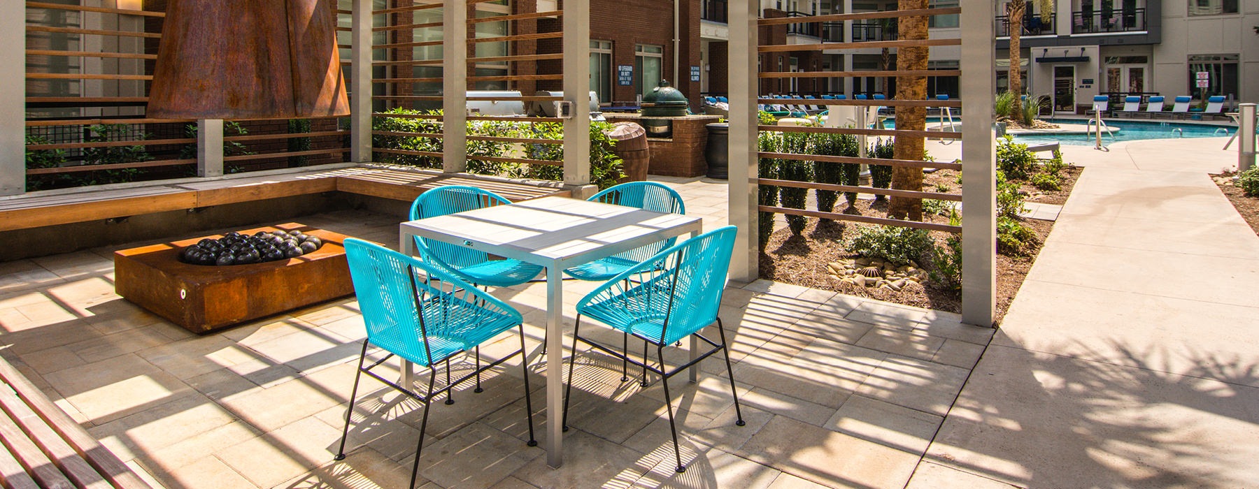 outdoor firepit and seating area near pool